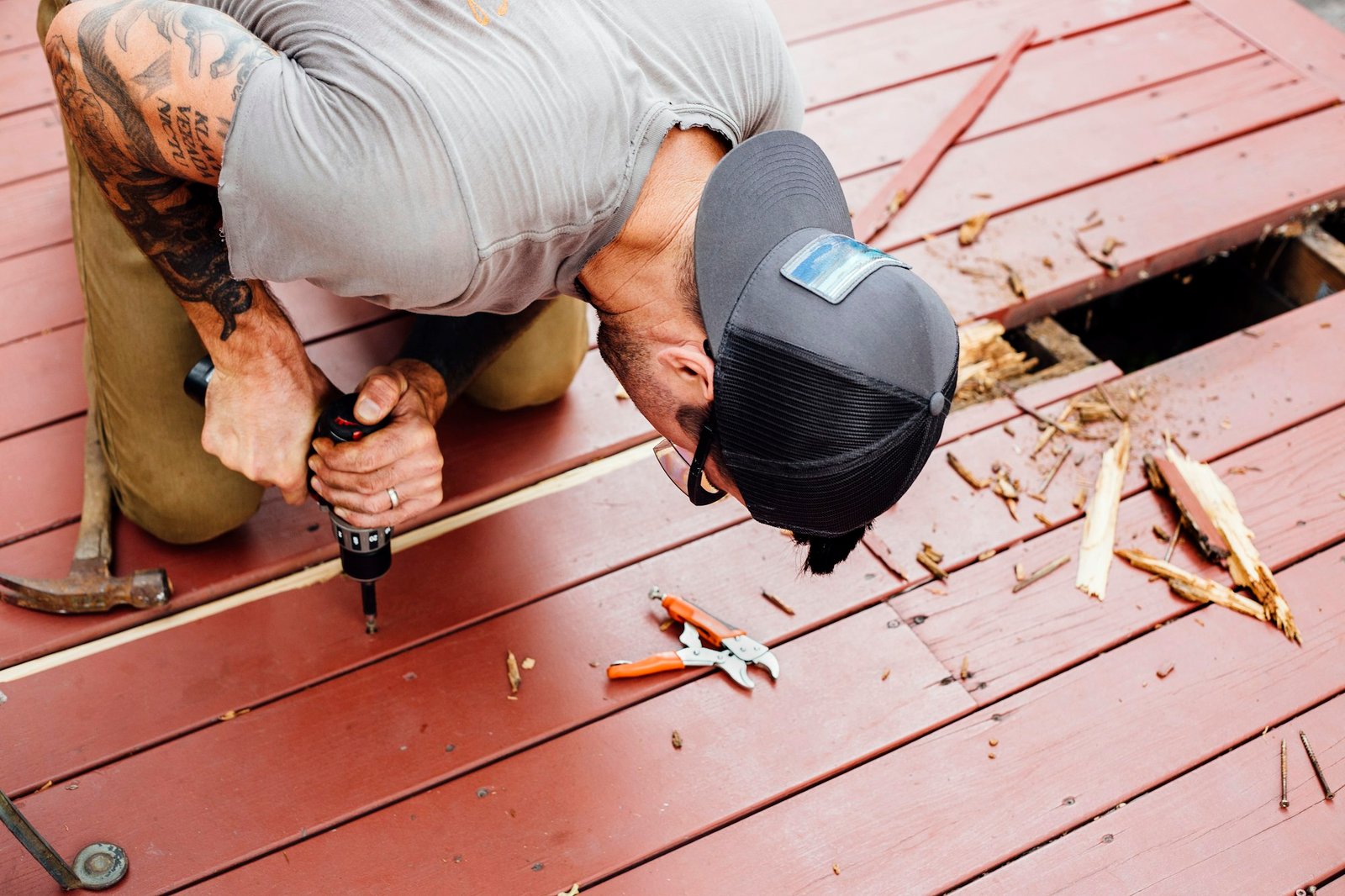 Man repairing wooden decking